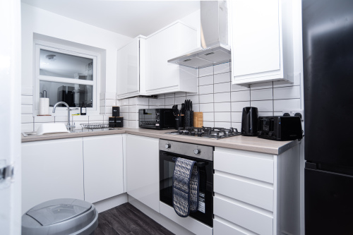Fully equipped modern kitchen with integrated appliances, dishwasher, all utensils, cleaning essentials and complimentary tea, coffee and sugar - everything you need for a home-from-home stay.