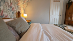 The fourth bedroom: second-floor serenity, double-bed comfort, and the bathroom just a few steps away.
