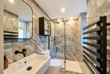 Immaculately designed shower with beautiful tiling and high-end detail