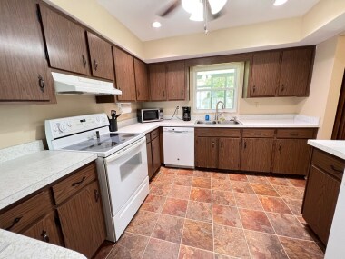 Enjoy a nice meal in this spacious kitchen stocked w/Dishes for cooking & dinning in.