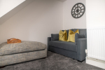 Separate two seater sofa bed nestled into the corner of the living room