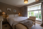Taupe bedroom with large window 