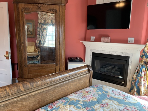 Antique armoire-flat screen--fireplace
