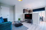 Spacious living room with comfortable seating and inviting atmosphere, perfect for relaxing or socialising during your stay.
