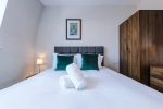 Comfortable bedroom with a king-size zip and link bed that can be separated into two singles upon request.