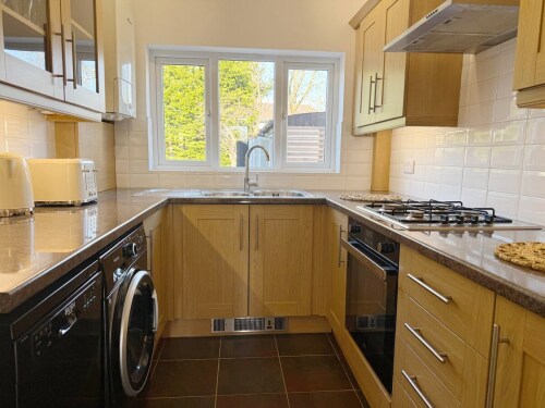 Cook with ease in this fully equipped kitchen, featuring modern appliances, ample counter space, and all essentials. Perfect for preparing delicious meals during your stay.