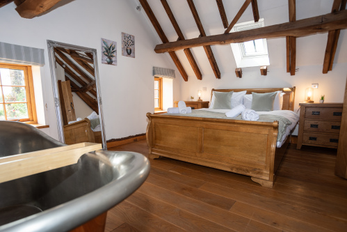 Luxurious bedroom with an in-room copper bath, offering a unique spa-style experience
