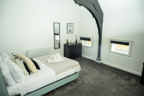 Sleep easy in this spacious double bedroom with soft linens and a relaxing ambience