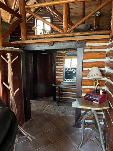 Hallway on main level leading to bedrooms and bathroom.