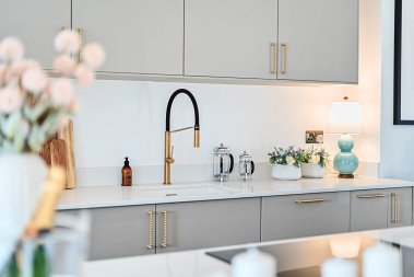 Luxury kitchen featuring a striking black sink with gold detailing.