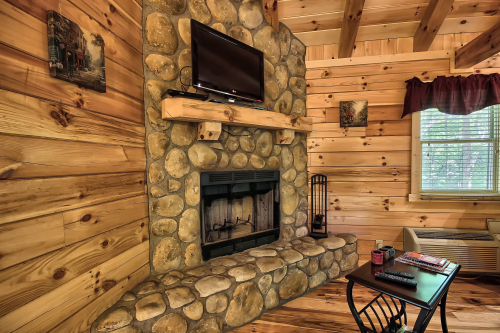 Closeup of Wood-Burning Fireplace, with River Rock, and TV screen (No TV access - Bring DVD's)