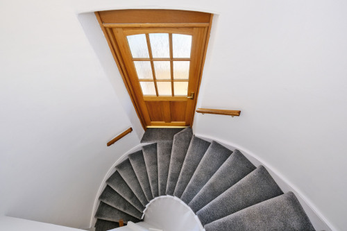 From private front door ascend the stairs to first floor, door midway leads to garden snug room and back door