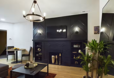 Step into this jazz-inspired retreat, where bold black accents meet warm wood floors. Relax by the striking black fireplace, lounge on the cozy sectional, or enjoy the stylish dining nook. This space harmonizes timeless elegance with modern comfort.