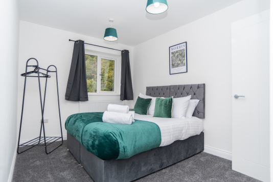 Bedroom with two single beds that convert into one king - a flexible zip-link setup perfect for any group. Just let us know your preferred layout before arrival.