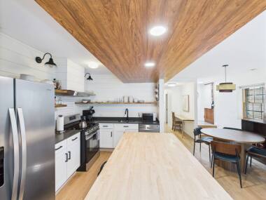 Cook and entertain in style in this fully equipped modern farmhouse kitchen, featuring sleek stainless steel appliances, a spacious butcher block island, and warm wood accents that create a welcoming space for friends and family.