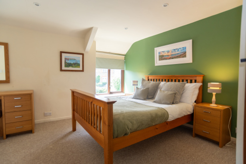 Wake up to garden views in the green room, one of two light, individually styled, double bedrooms
