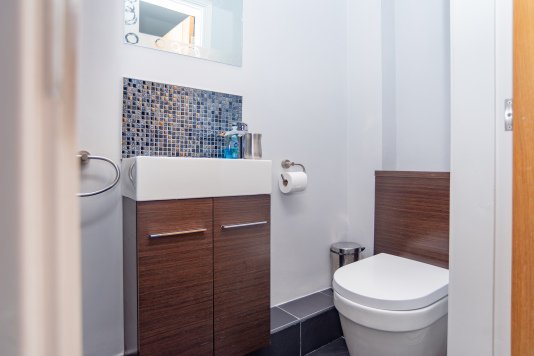 Downstairs WC with a clean, modern finish for quick convenience during your stay.