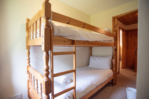 Bunk Room, Sleeps Two - Pine bunk beds with fresh white linens and towels provided, perfect for kids or extra guests joining the group.