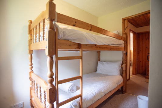Bunk Room, Sleeps Two - Pine bunk beds with fresh white linens and towels provided, perfect for kids or extra guests joining the group.