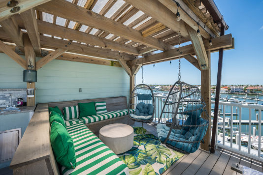 Pergola is covered to keep you,  the furniture and kitchen dry