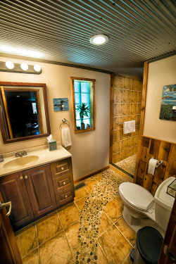 Bathroom with a stone path leading to large walk-in shower