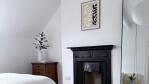 Bright bedroom with Victorian fireplace and pendant light