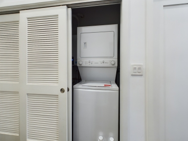 Convenient in-unit laundry area with a stacked washer and dryer. We provide all your laundry care needs, including detergent and dryer sheets, so you can pack light and enjoy a worry-free stay. 