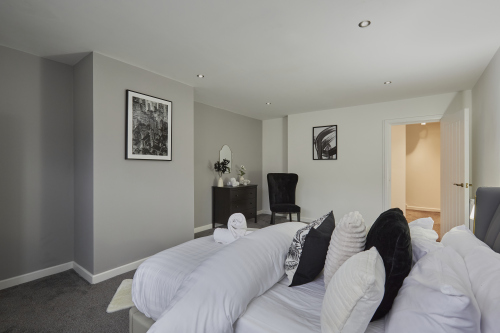 Sleep easy in this spacious double bedroom with soft linens and a relaxing ambience.