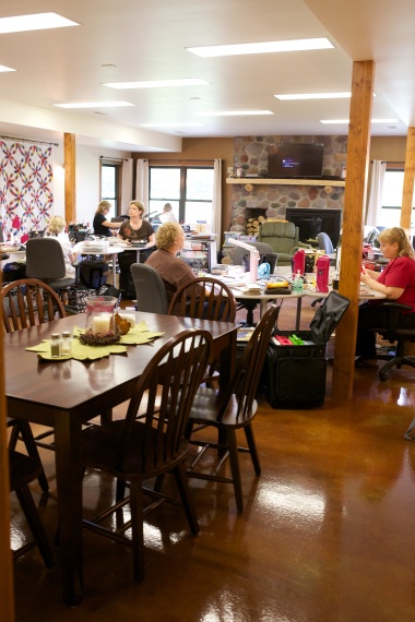 Main Gathering Room with craft tables and dining space.