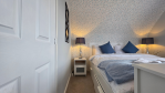 Rest easy in the third bedroom. A queen-size bed awaits, along with a workstation and plenty of space to unpack.