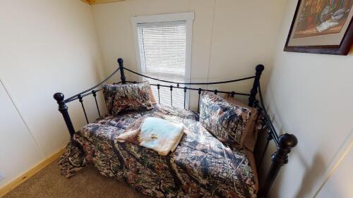 Second bedroom featuring a trundle bed with two twins