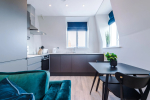 Spacious living room with comfortable seating and inviting atmosphere, perfect for relaxing or socialising during your stay.