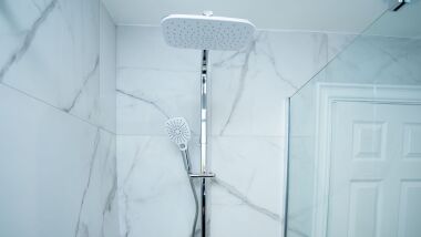 A fresh, modern, fitted bathroom, with a walk in shower. Toiletries and  hotel style towels provided.