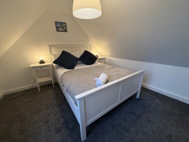 Comfortable double bed with quality linen, located on the second floor.