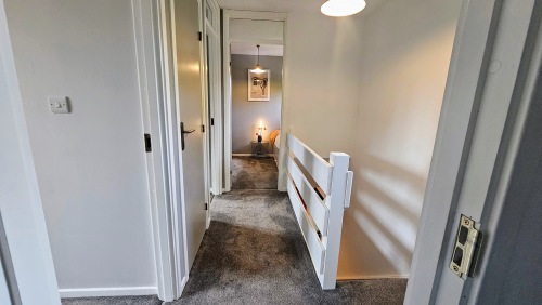 Upstairs hallway leading to single room 