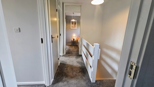 Upstairs hallway leading to single room 