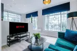 Spacious living room with comfortable seating and inviting atmosphere, perfect for relaxing or socialising during your stay.