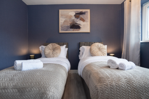 Spacious bedroom with a versatile setup — choose a comfy king bed or two singles. Features large wardrobes for easy storage throughout your stay.