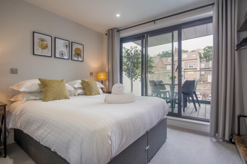 Bedroom one, leading onto balcony with views of the Minster.