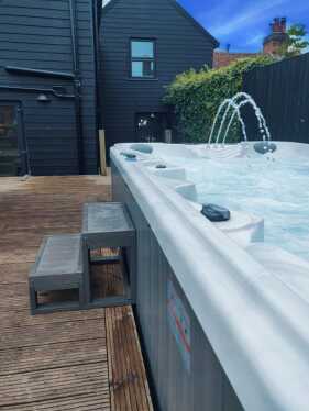 Within the garden on the decking guests can enjoy the huge luxurious 10 person hot tub 