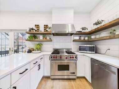Open shelving, warm textures, and modern appliances create a space worth lingering in.