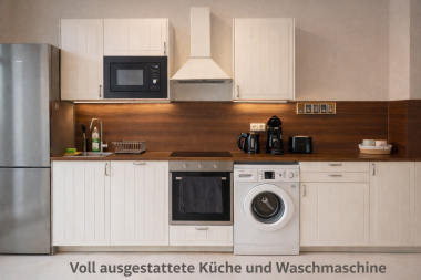 Fully equipped kitchen with large refrigerator & freezer, oven, induction cooktop, kettle, microwave, dishwasher, and washing machine
