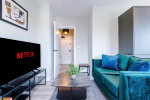 Spacious living room with comfortable seating and inviting atmosphere, perfect for relaxing or socialising during your stay.