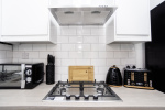 Fully equipped kitchen with oven, hob, kettle, toaster and microwave, giving guests everything needed for home-style cooking