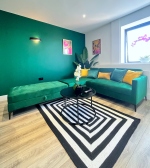 Living area with large chaise sofa bed for extra guests.