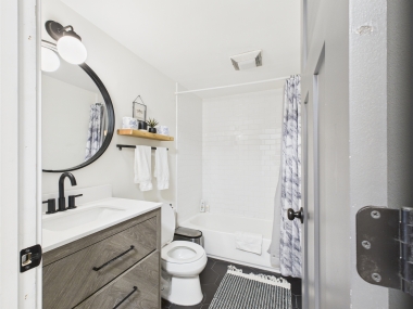 Bathroom One: modern vanity and curated accessories for a hotel-level experience.