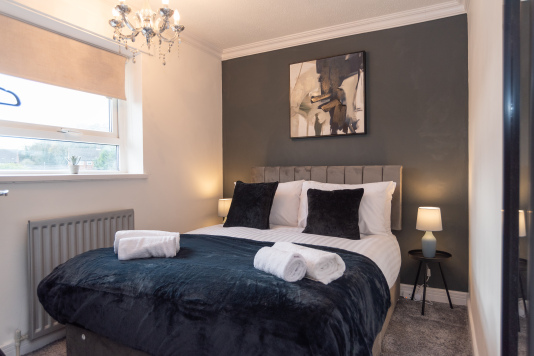 Inviting and cosy bedroom with a comfortable double bed, hotel-quality linen and fresh towels. Enjoy garden views and convenient wardrobe space for an easy home-from-home stay.