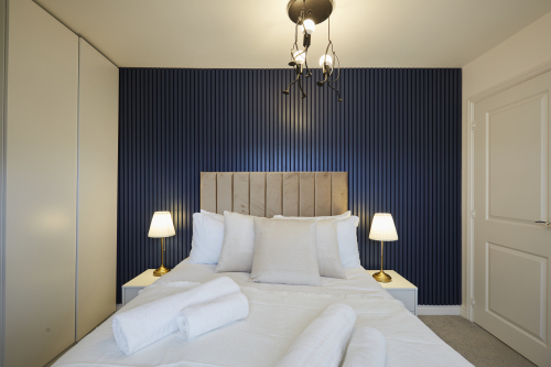 Cozy bed dressed in fresh hotel-quality linens.