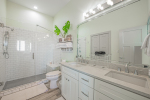 Primary suite bathroom has walk-on shower with hand spray