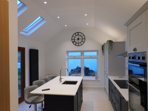Stylish kitchen with social seated island and smart TV wall mounted